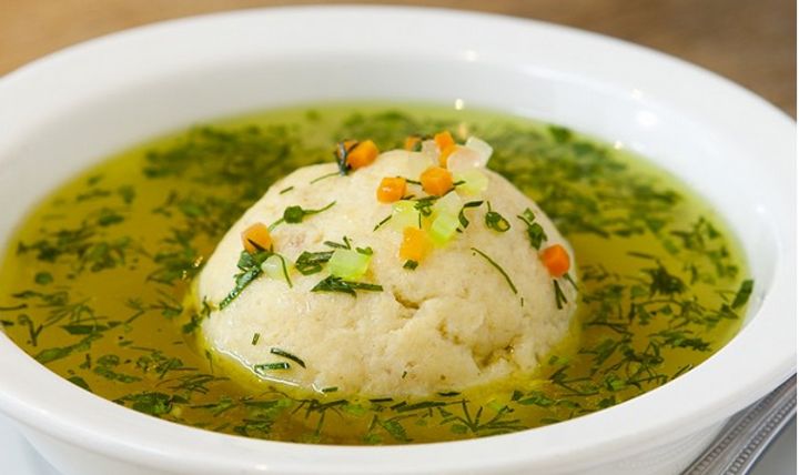 a white bowl filled with soup on top of a table