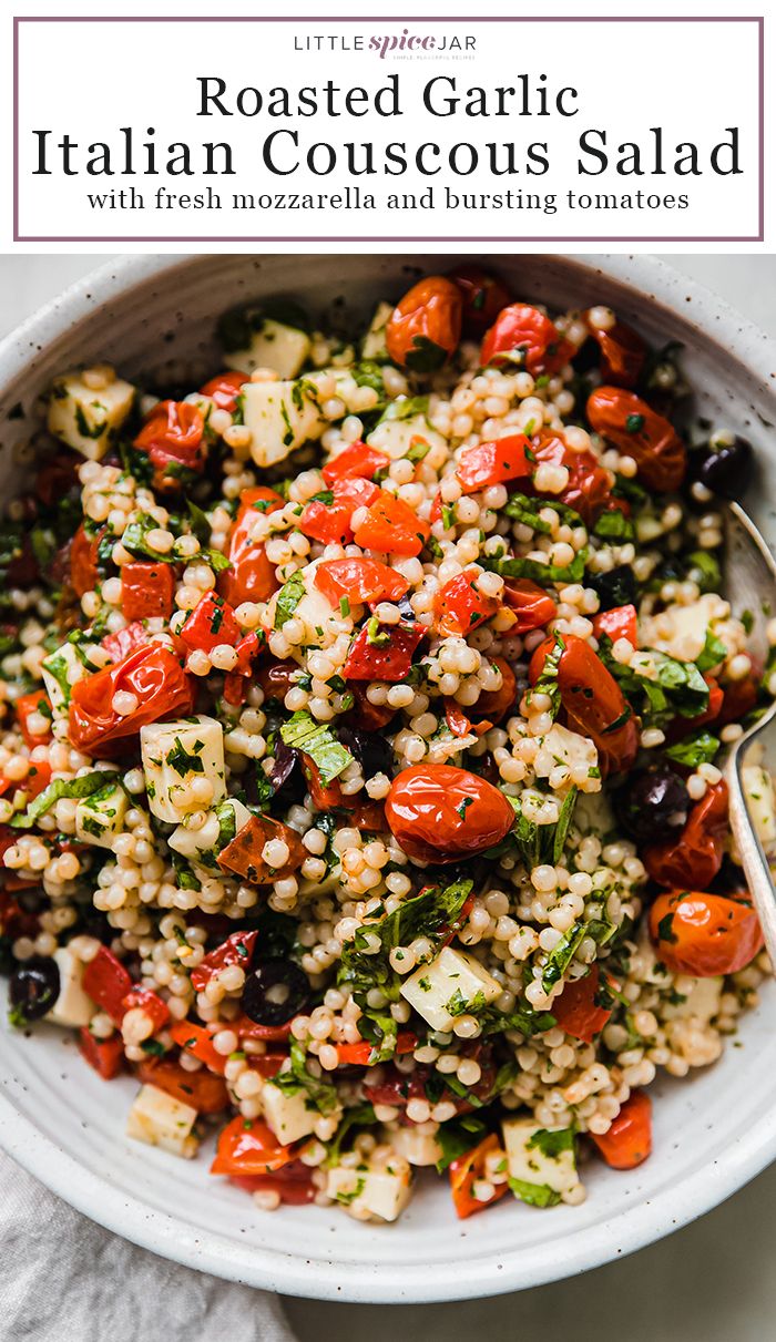 a white bowl filled with couscouse and tomatoes on top of a table