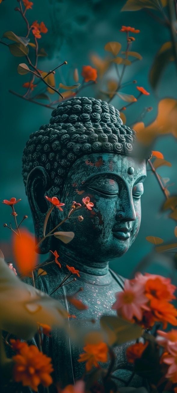 a buddha statue surrounded by flowers and leaves