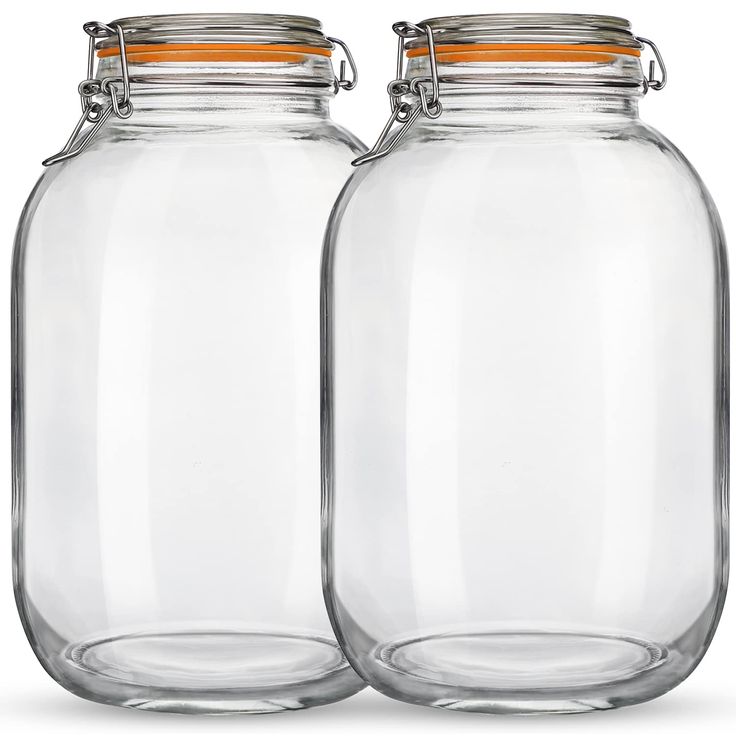 two clear glass jars with metal lids on each one and an orange stripe at the top