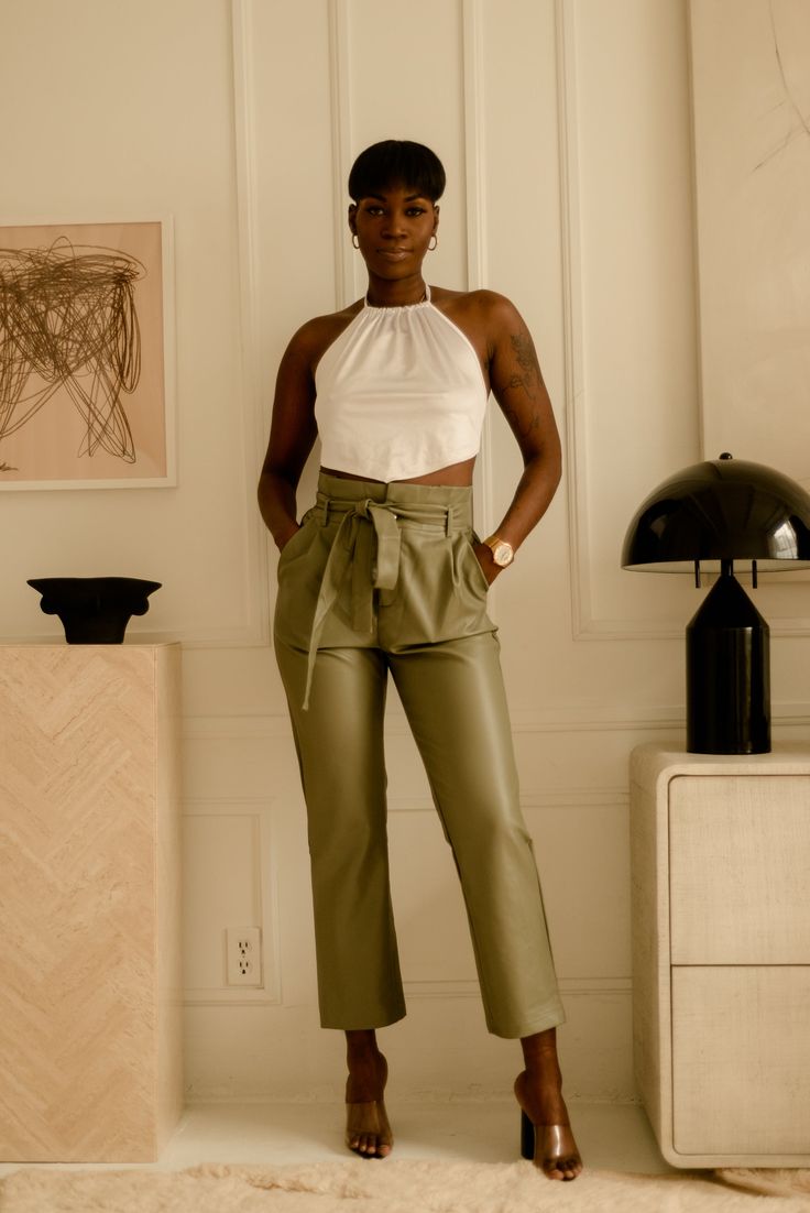 Get ready to make a statement in these beautiful olive green coloured pants. High waisted with pockets and an adjustable front tie to add your own flare of fierceness to your look! Our Sasha pants are perfect for your spring wardrobe and can be paired with a lovely blouse and accessories to compliment. *Accessories and top are not included Fabric: Faux leather, 55% Cotton 45% PU Model is wearing size small Shipping: ﻿Please visit our shipping policy for more information Chic Olive Summer Pants, Olive High-waisted Pants For Spring, Chic Olive High Waist Bottoms, Trendy Olive Pants For Spring, Chic Olive Bottoms For Spring, Chic Olive High-waisted Pants, Olive Spring Trousers, Spring Olive Trousers, Chic High-waisted Cargo Pants For Day Out