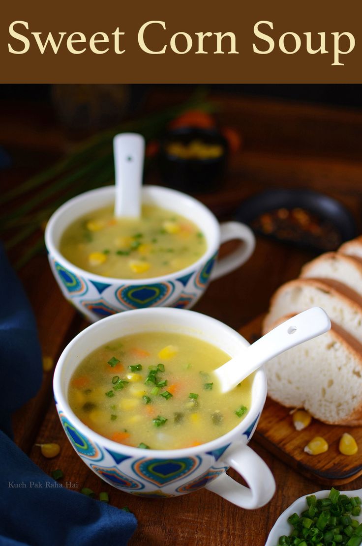 two bowls filled with soup next to some bread