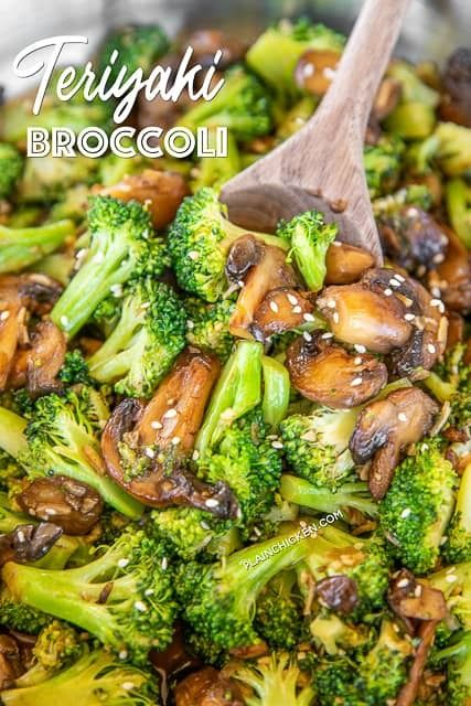 broccoli and mushrooms stir fry in a pan with a wooden spoon