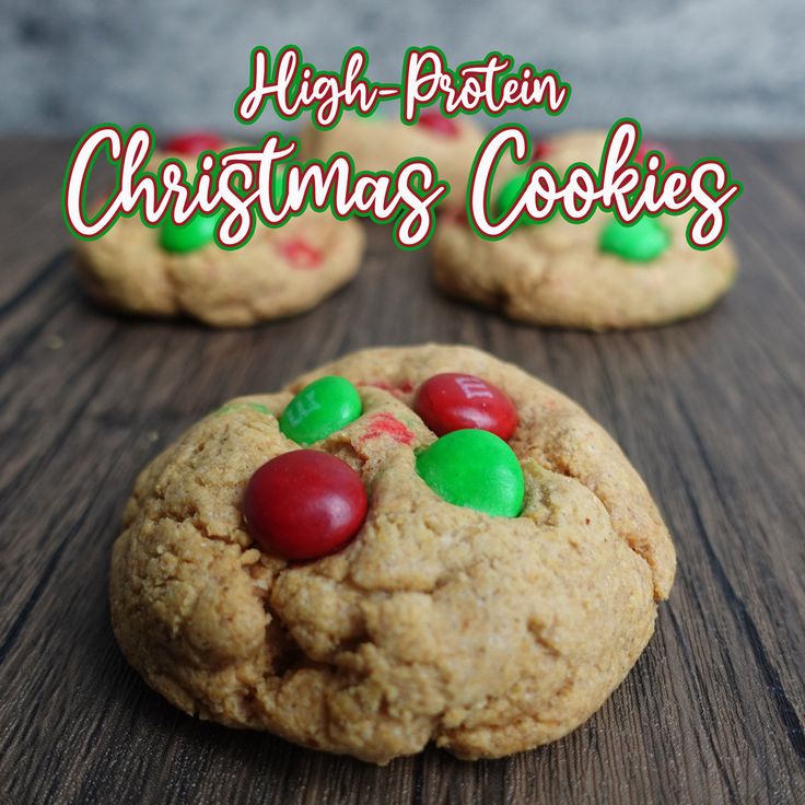 cookies with m & m candies on top and the words high - protein christmas cookies above them