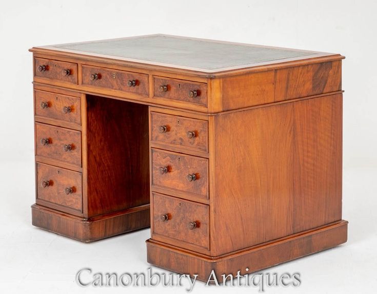 an antique wooden desk with drawers on it