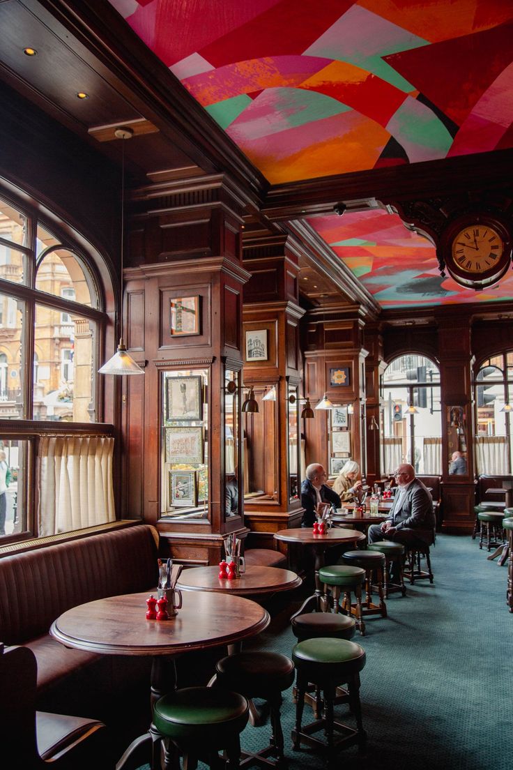 the interior of a restaurant with many tables and chairs