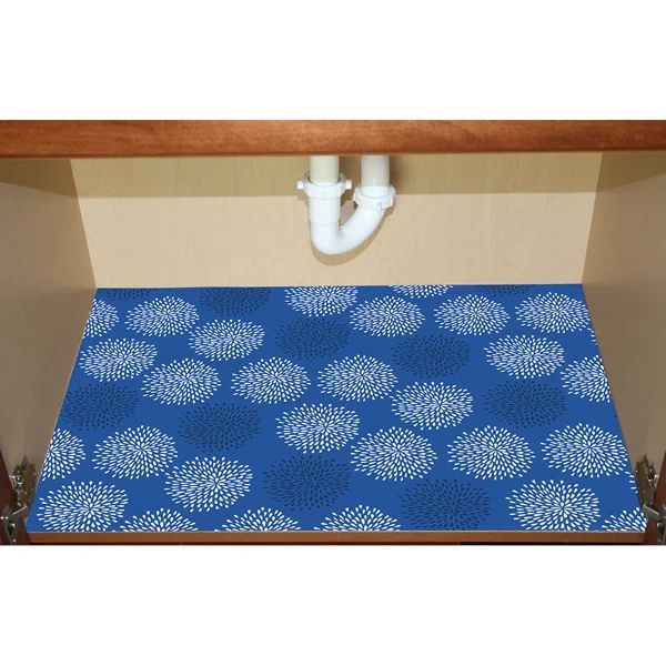 a blue area rug in the corner of a room with pipes coming out of it