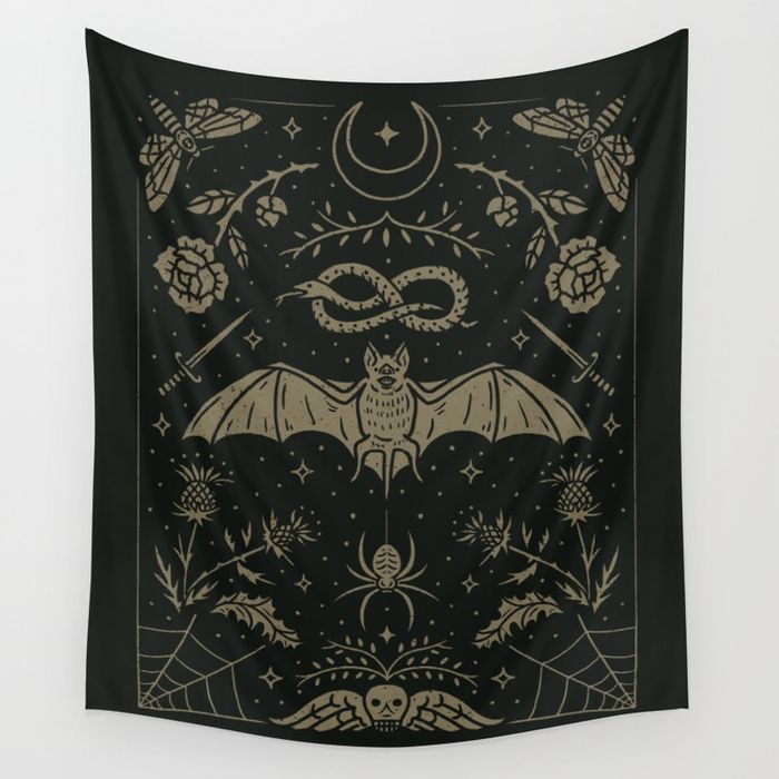 a bat hanging on the wall in front of a black background with gold and white designs