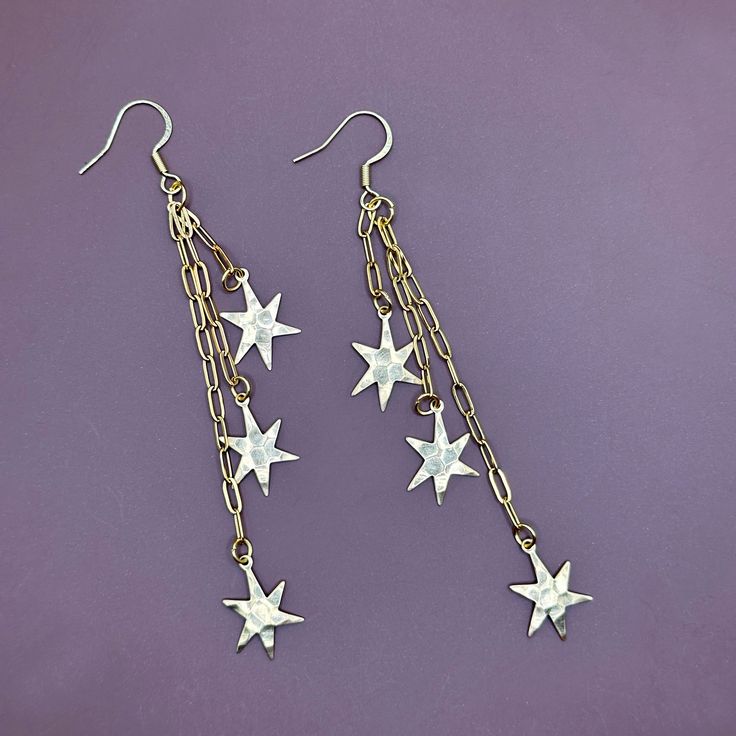 These gold earrings have varying lengths of chain with small irregular stars dangling from each strand. The textured stars are very lightweight and made of brass. Approx. 4"Hammered star charms are lightweight brass. The chain and ear hooks are made of stainless steel. -------------- 🔨 I stamp each letter/design by hand with traditional tools so each item is truly one of a kind. This also means your piece won’t look exactly as pictured. Due to the nature of stamping there may be a slight impres Star Earrings Dangle, Stamp Letter, Earring Pins, Diy Jewelry Ideas, Heart Dangle Earrings, Letter Design, Worry Stones, Car Charms, Ear Hook