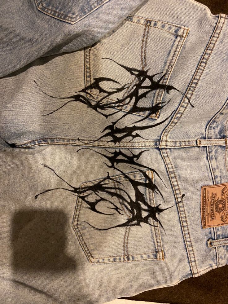 an old pair of jeans with trees on them