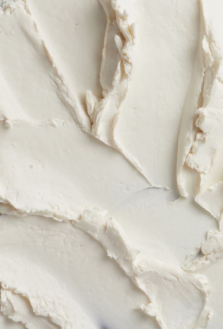 white frosted cake sitting on top of a table