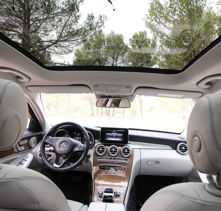 the interior of a car with dashboard, steering wheel and center console in front of it