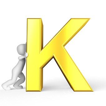 a person leaning against the letter k