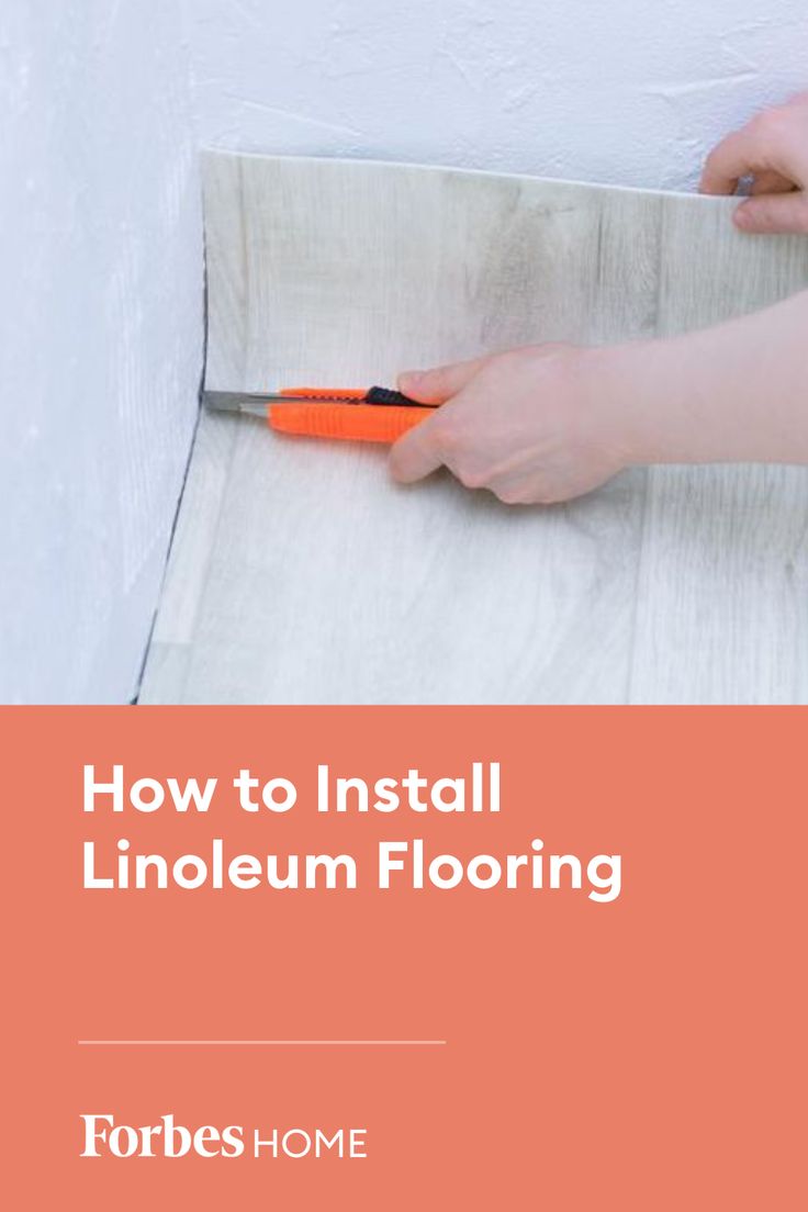 someone using a pair of scissors to install linoleum flooring on a wall