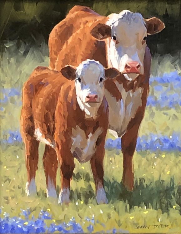 two brown cows standing next to each other on a grass covered field with blue flowers