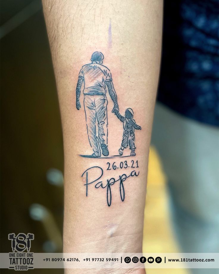 a man with a dog on his arm has a tattoo that reads papa and is holding the hand of a child