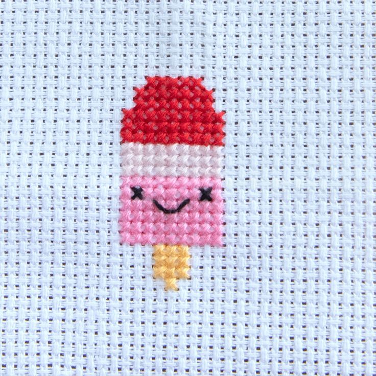 a cross stitch pattern with an ice cream cone on it's face and eyes