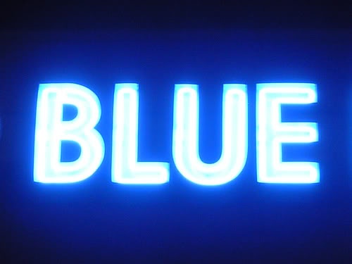 the word blue is lit up against a dark background