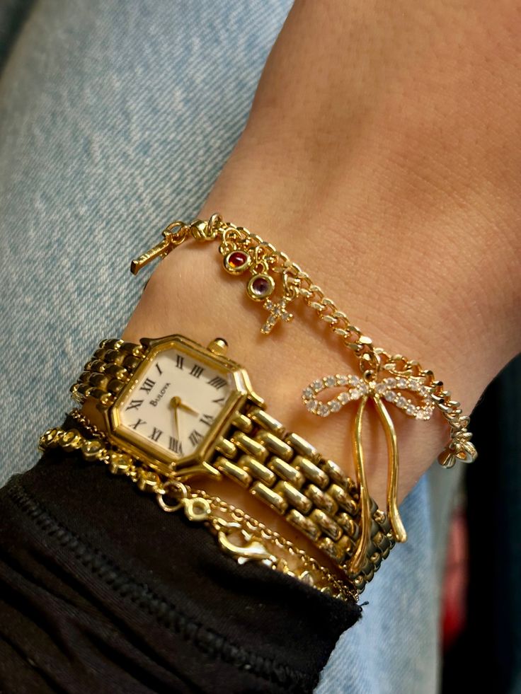 Charm bracelet Bow charm Gold watch Gold charms Bracelet Stack Ideas With Watch, Gold Watch Jewelry, Gold Jewelry Stacking, Gold Bracelet Inspiration, Golden Bracelet Stack, Shop The Deli Jewelry, Chunky Gold Bracelet Stack, Gold Jewelry Stack Bracelet, Cute Gold Watch