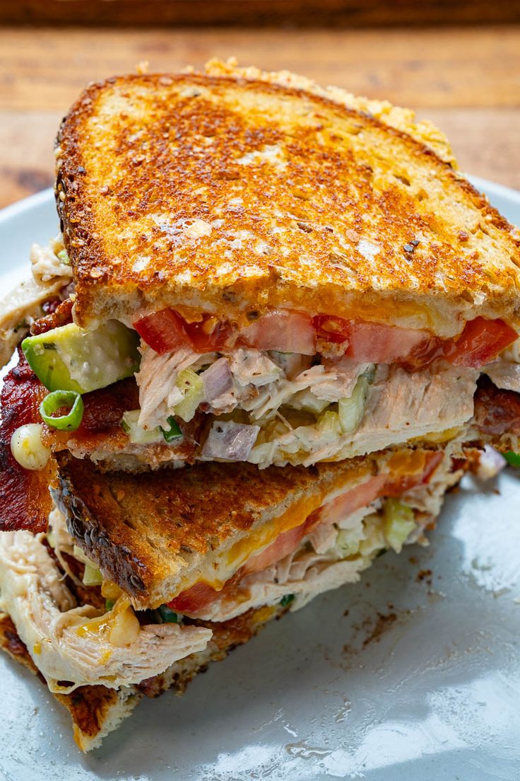 a sandwich cut in half sitting on top of a white plate