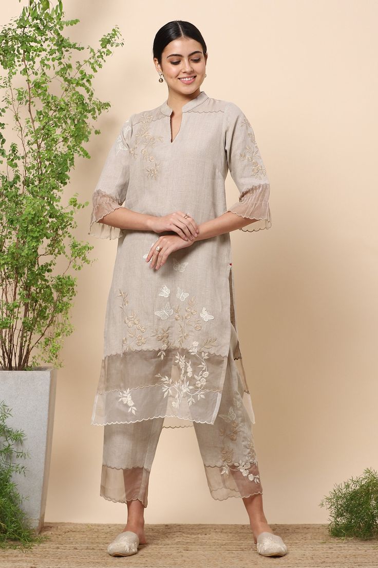 Natural kurta with butterfly print, butterfly applique work and floral embroidered motifs. Comes with straight pants.
Components:2
Pattern:Print and Embroidery
Type of Work:Butterfly Print, Butterfly Applique and Thread Embroidery
Neckline:Band
Sleeve Length:Three Quarter
Fabric:Linen
Color:Beige
Other Details:
Sleeves with pleated hems
Scalloped hem
Side slits
Pant with organza panel
Occasion:Work - Aza Fashions Applique Kurta, Linen Suits Women, Layered Kurta, Embroidery Butterfly, Embroidery Neckline, Butterfly Applique, Kurta Pant Set, Kurta Set For Women, Applique Work