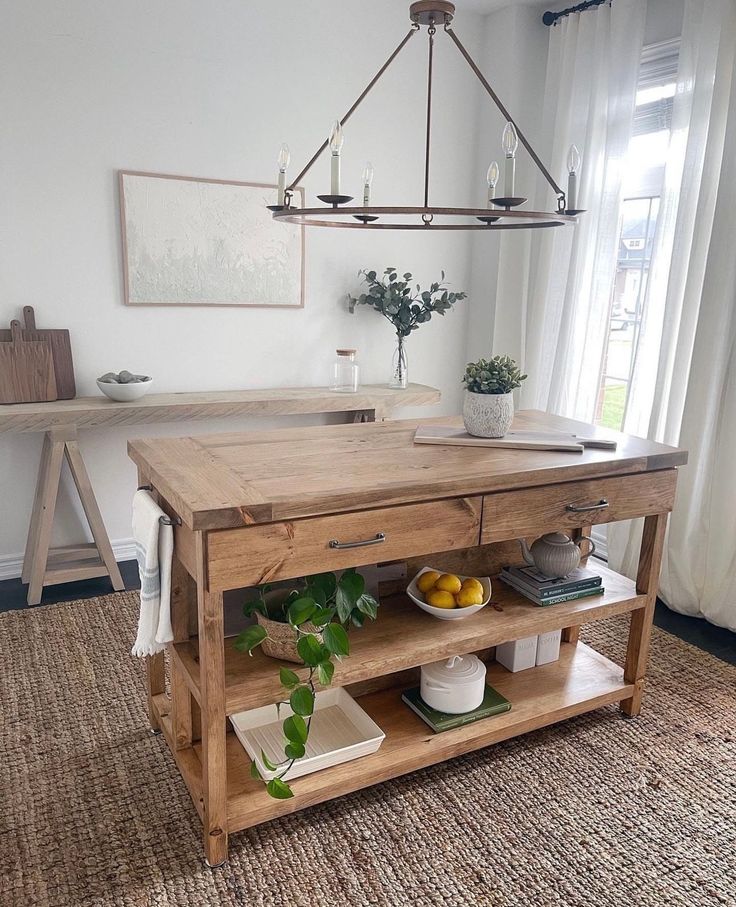 a kitchen island made out of wooden planks with plants and fruit on the top