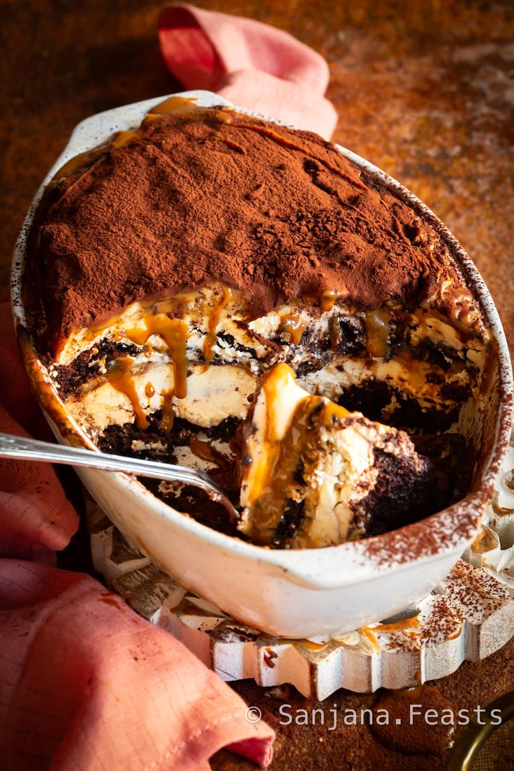 a person holding a spoon in a bowl filled with dessert