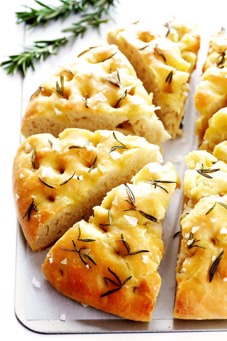 slices of bread with rosemary sprigs on top