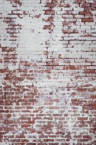 an old red brick wall with white paint