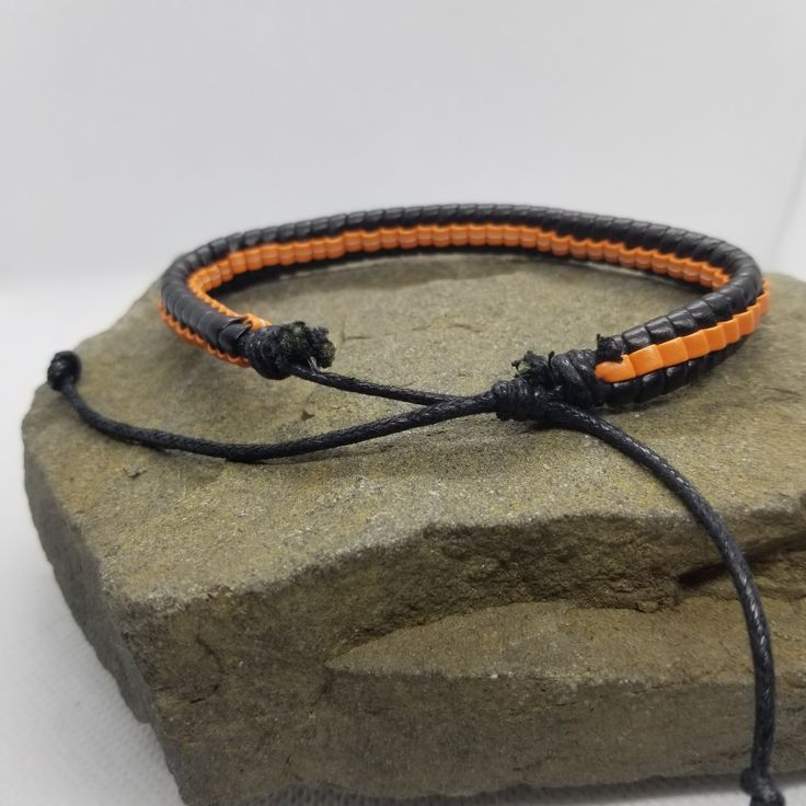 If you like orange and black, then this simple bracelet is perfect for you to add to your collection. The bracelet is adjustable via a sliding knot. Product Information Material: PU leather Clasp Type: rope (sliding knot) Adjustable: 6.5 inches to 8 inches Adjustable Orange Beaded Bracelets For Everyday, Minimalist Adjustable Bangle Wristband, Adjustable Casual Wristband Bracelet, Black Beaded Bracelet With Sliding Knot, Black Beaded Bracelet With Sliding Knot For Friendship, Friendship Black Beaded Bracelet With Sliding Knot, Trendy Adjustable Orange Jewelry, Adjustable Orange Bangle Jewelry, Adjustable Black Friendship Bracelet