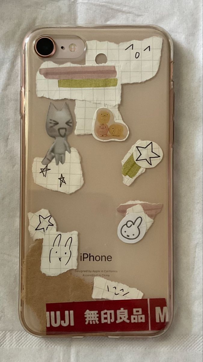 an iphone case with some stickers on the back of it, and other things