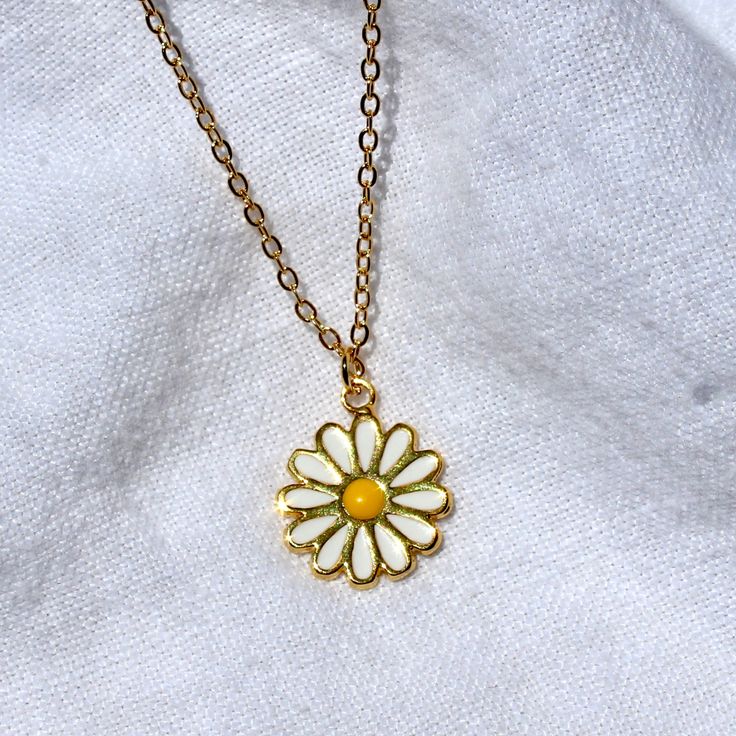 This necklace features an enamel 14x17mm daisy charm attached to a 16" chain. All materials are 24k gold plated, tarnish resistant, lead, and nickel free. Matching earrings available here. Full necklace and earrings set available here. 70s Jewelry Necklaces, Cute Gold Jewelry With Flower Charm, Dainty Flower-shaped Enamel Jewelry, Dainty Yellow Flower Shaped Jewelry, Trendy Flower Shaped Necklace As Gift, Trendy Gold Flower-shaped Jewelry, Gold Enamel Flower Pendant Necklace, Cute Gold Necklace With Flower Charm, Gold Enamel Flower Jewelry