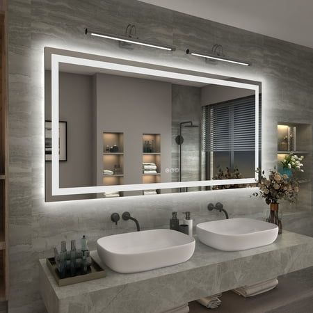 a bathroom with two sinks and a large mirror