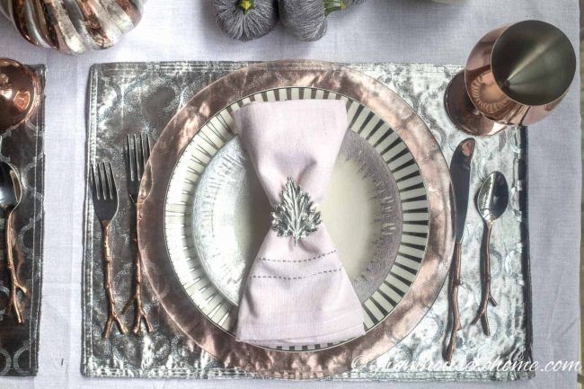 a place setting with silverware and napkins