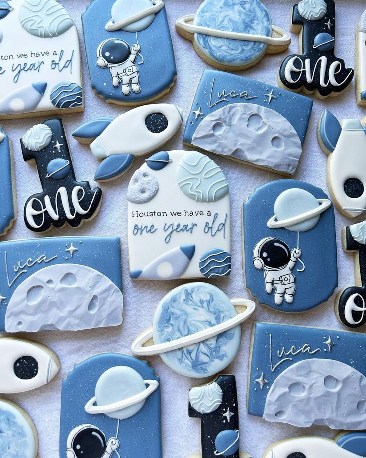 some cookies that are decorated to look like the moon and astronaut's landing gear