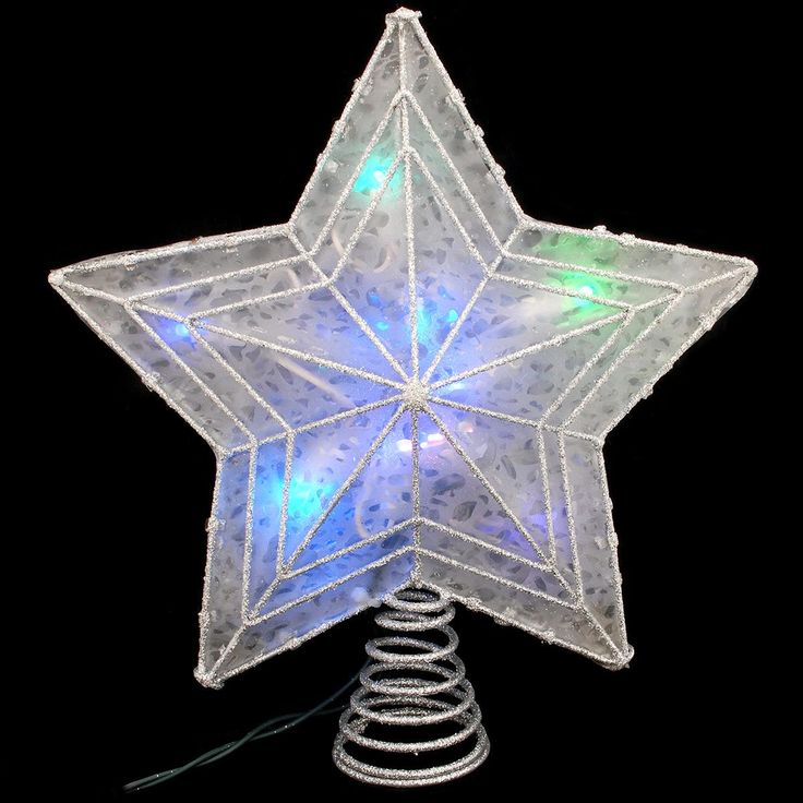 a white star shaped ornament sitting on top of a metal spiral wire stand