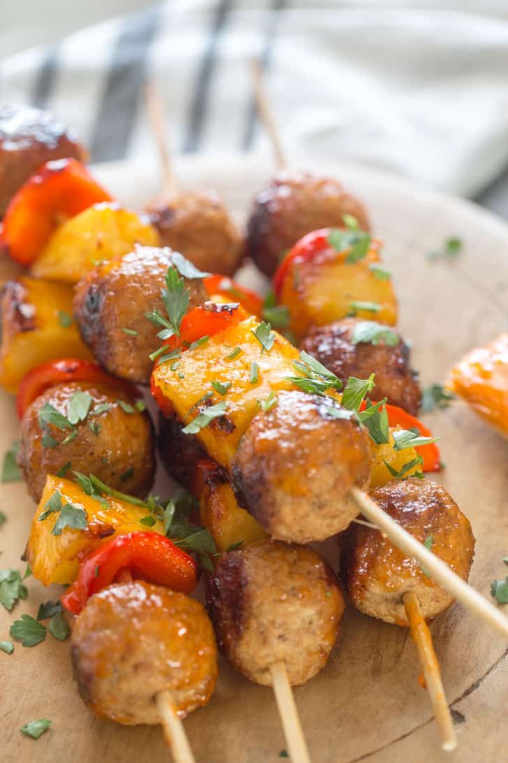 several skewers of meat and vegetables on a plate