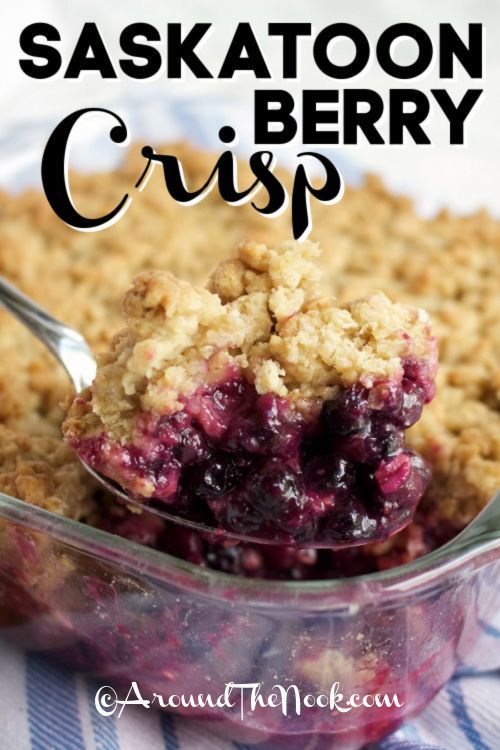 a close up of a spoon in a bowl of food with the words saksatoon berry crisp above it