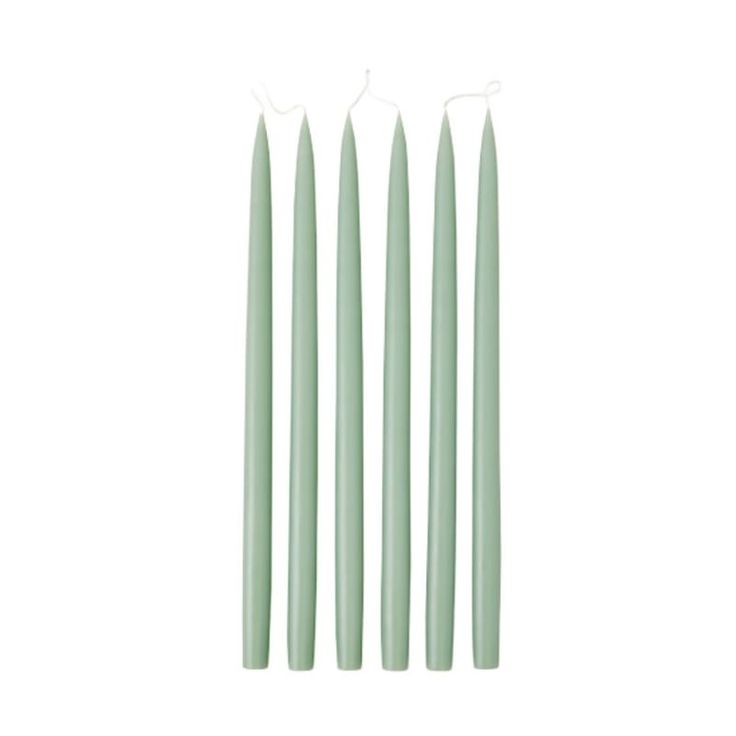 three green candles sitting next to each other