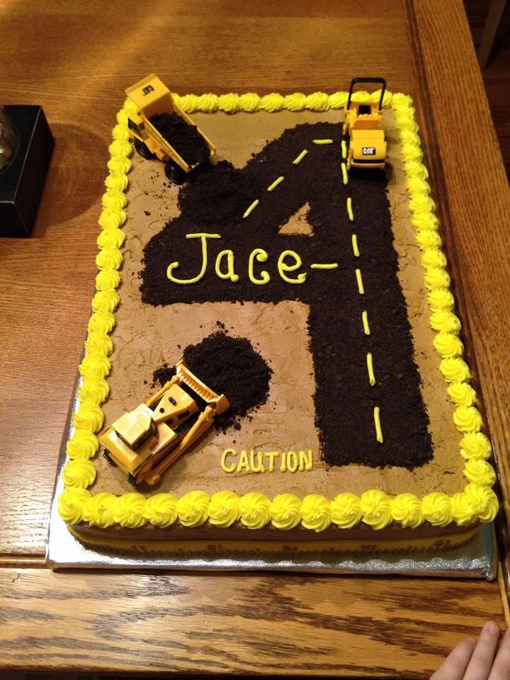 a cake that is shaped like a road with cars on it and the name jace