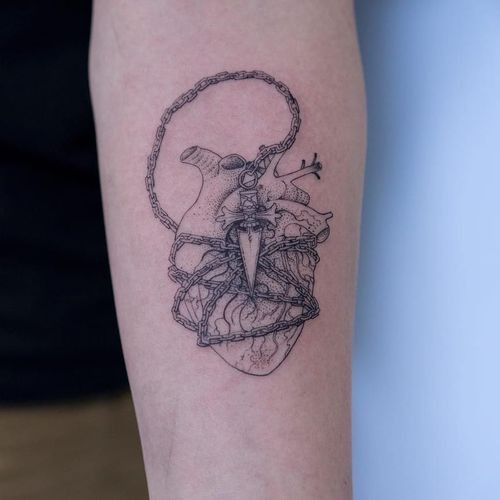 a tattoo on the arm of a woman with an elephant and chain around her neck