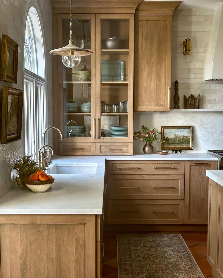 a kitchen with wooden cabinets and white counter tops