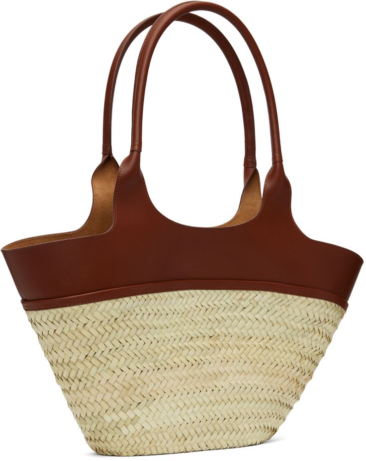 Woven straw tote in beige. · Buffed leather trim throughout · Twin carry handles · Logo stamp at face · Open throat · Unlined · H10.5 x W20 x D3.5 Supplier color: Noisette Designer Straw Bag With Bamboo Handle For Travel, Brown Leather Straw Bag With Rolled Handles, Designer Natural Straw Bag With Bamboo Handle, Designer Natural Basket Straw Bag, Designer Natural Color Basket Straw Bag, Designer Straw Basket Bag With Leather Handles, Designer Natural Straw Bag With Handles, Designer Natural Straw Bag, Designer Brown Woven Straw Bag