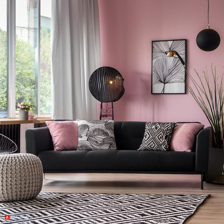 a living room with pink walls and black furniture