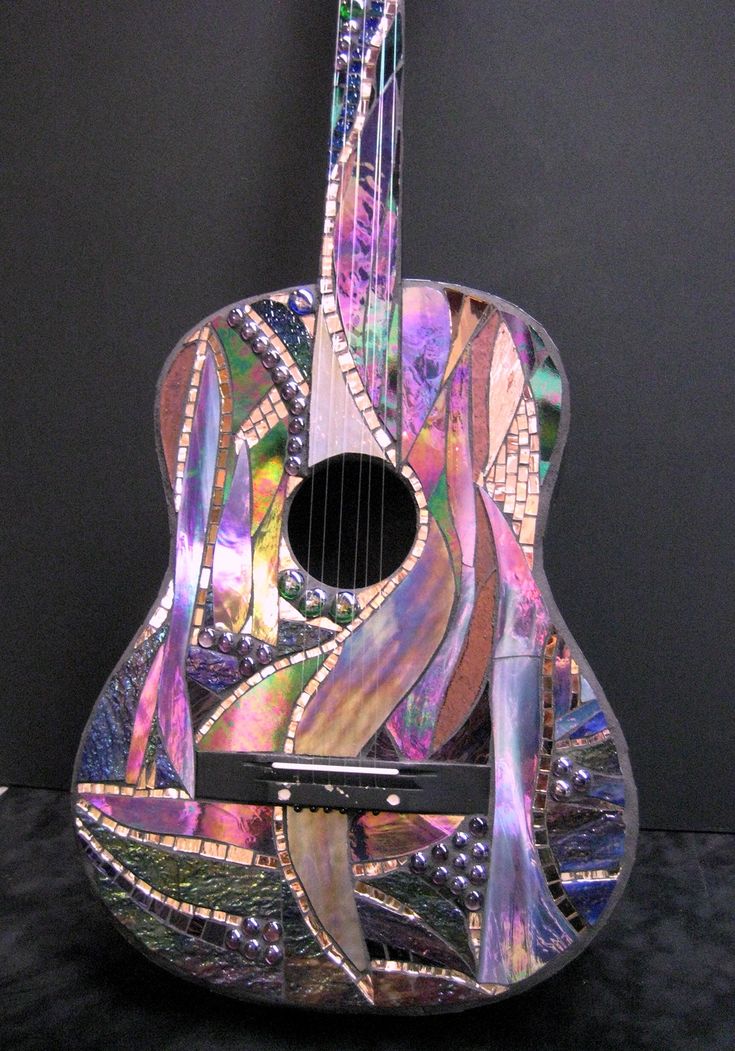 a colorful guitar sitting on top of a table