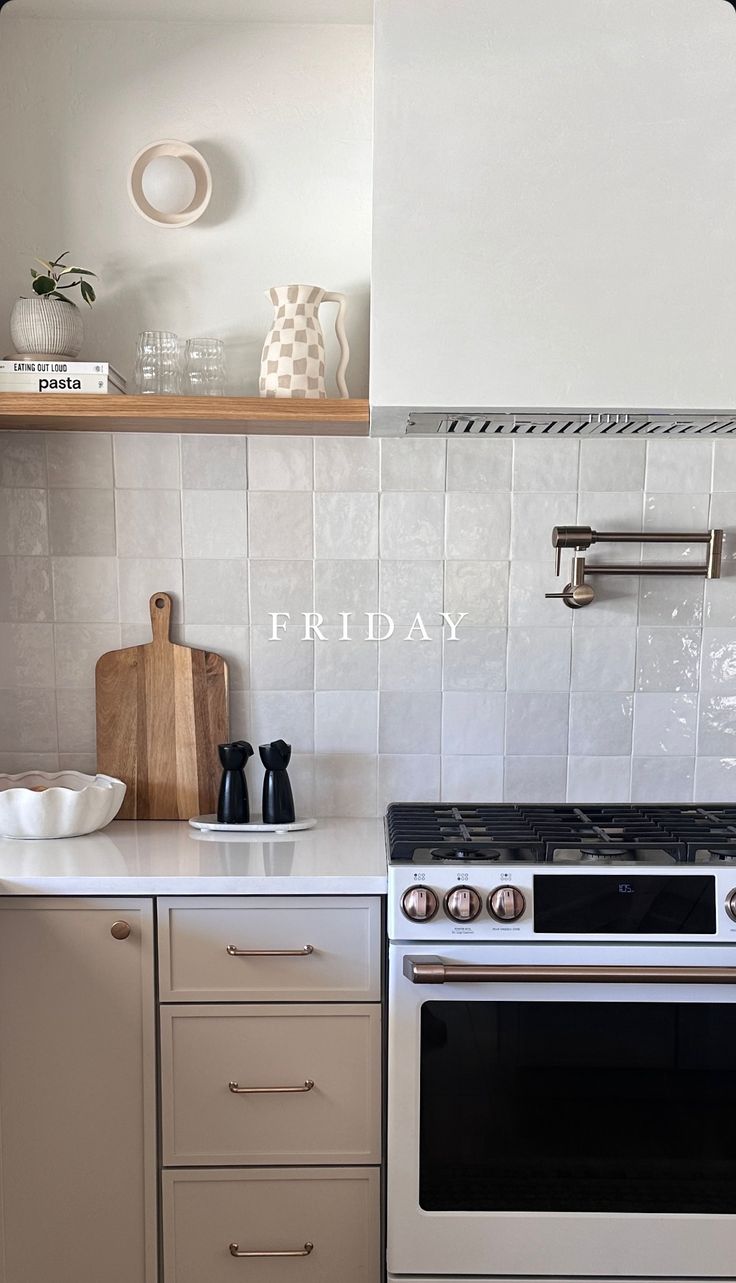 a white stove top oven sitting inside of a kitchen next to a wooden cutting board