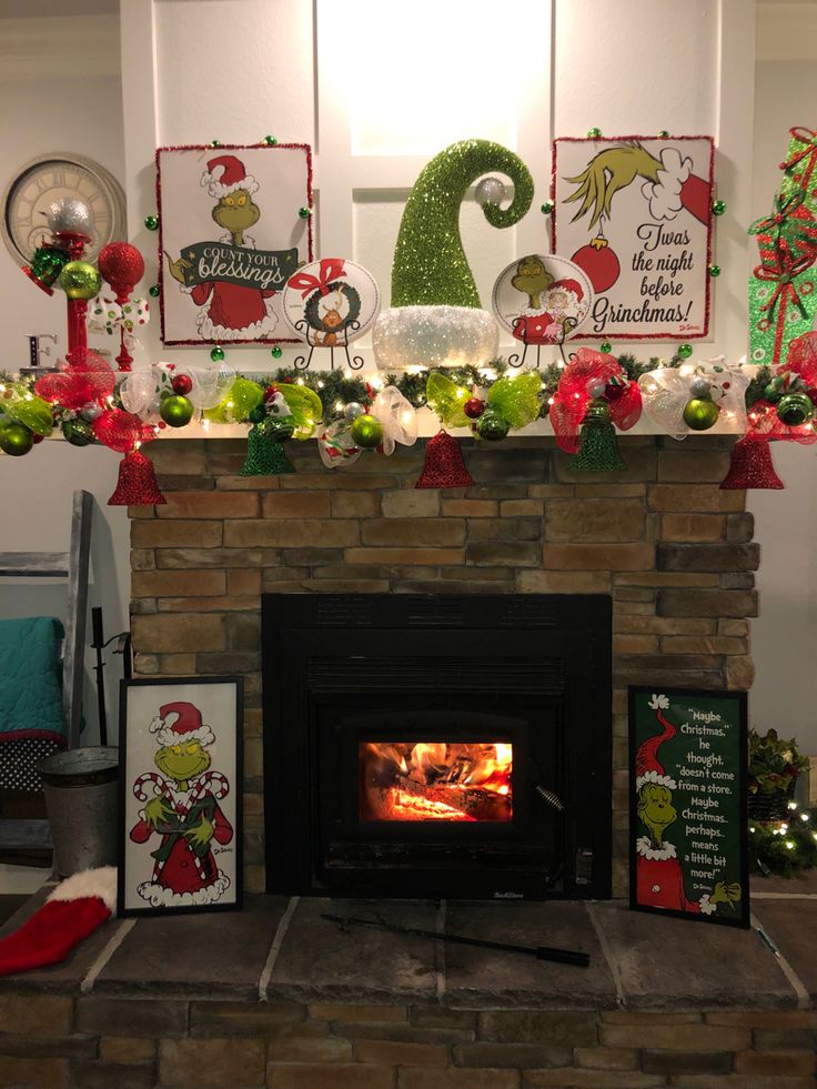 a fireplace decorated for christmas with decorations and pictures on the mantel above fire place