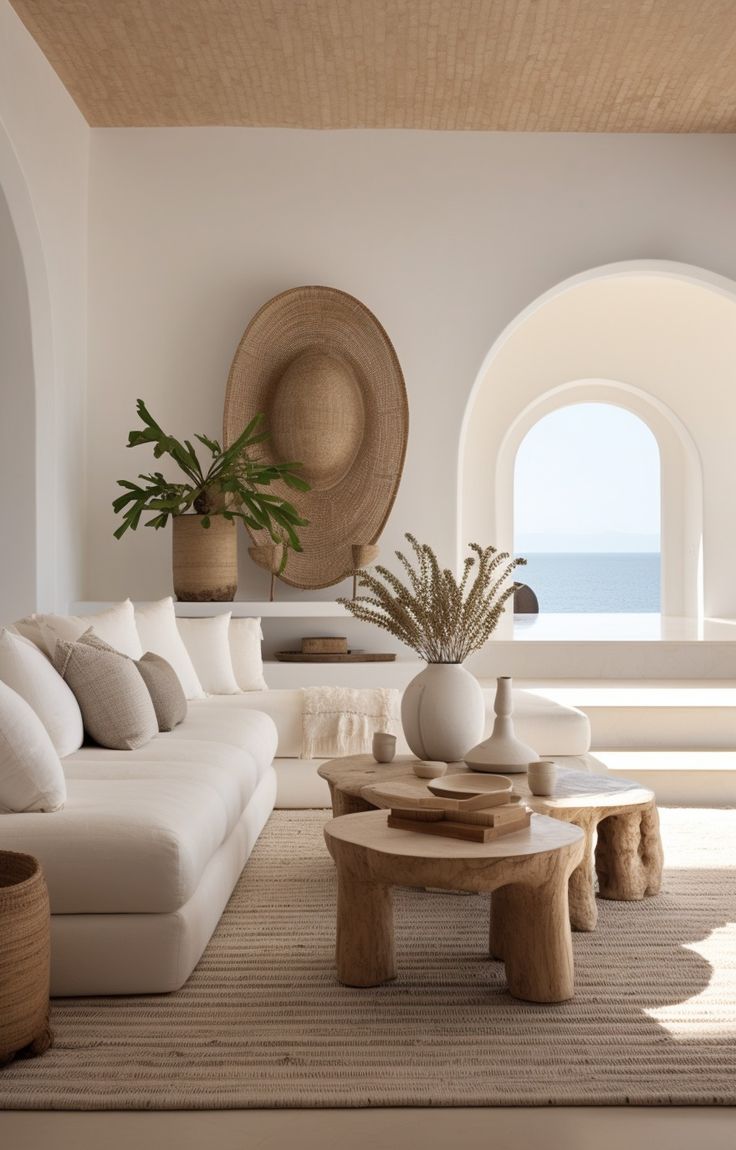 a living room filled with furniture and a large window overlooking the ocean in an arch