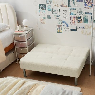 a bedroom with white furniture and pictures on the wall