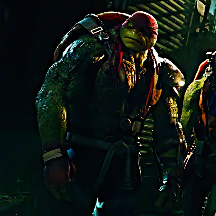 two teenage boys dressed as teenage mutant ninjas standing next to each other in the dark